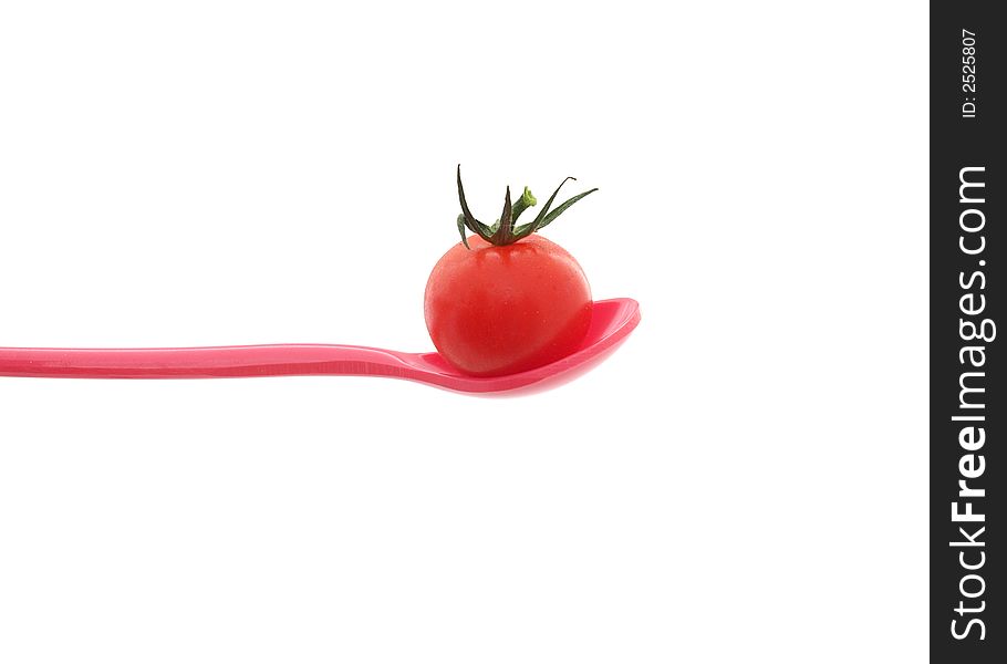 Cherry tomato on a red spoon