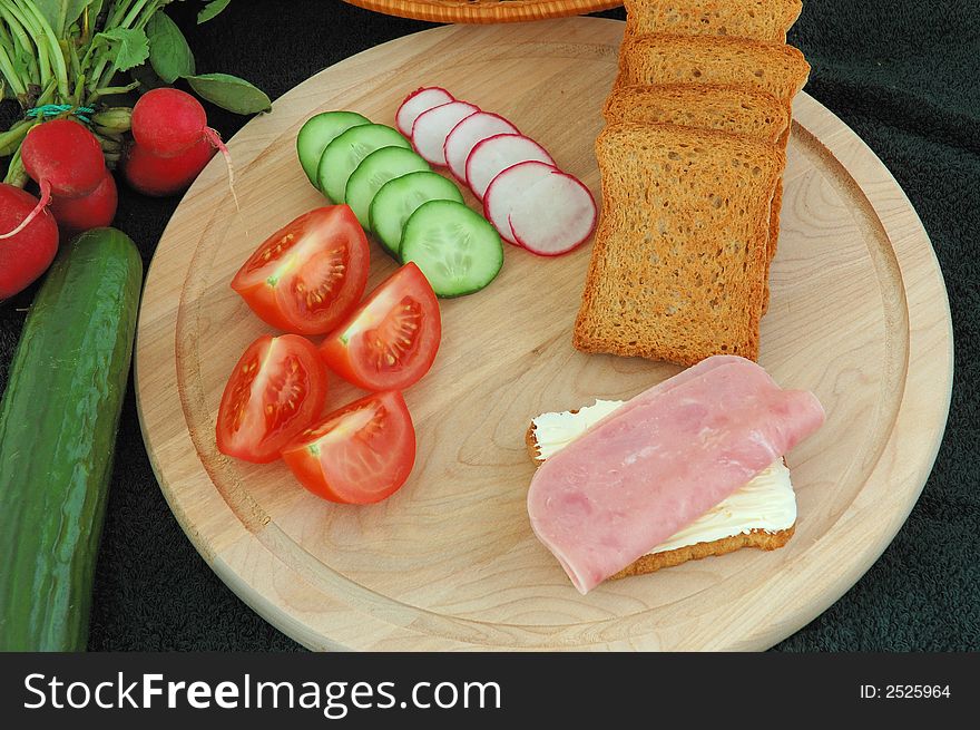 Diet cracker with butter, ham and vegetables on the table. Diet cracker with butter, ham and vegetables on the table.