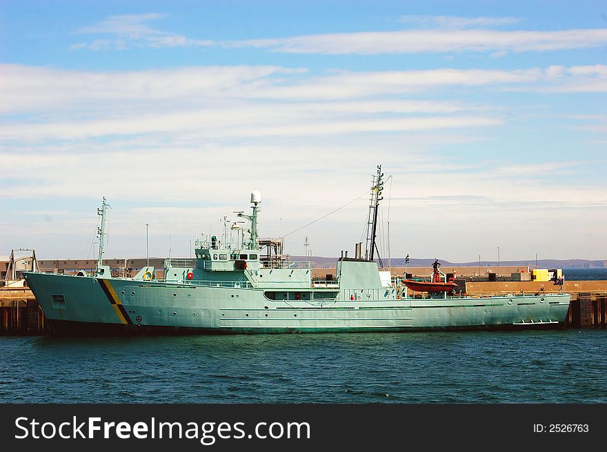 A fisheries patrol vessel in port.