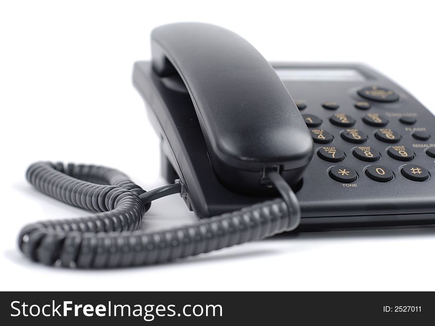 Office style black telephone over white background. Office style black telephone over white background