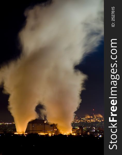 Vertical color image of two steam columns from coal fueled power plant. Vertical color image of two steam columns from coal fueled power plant