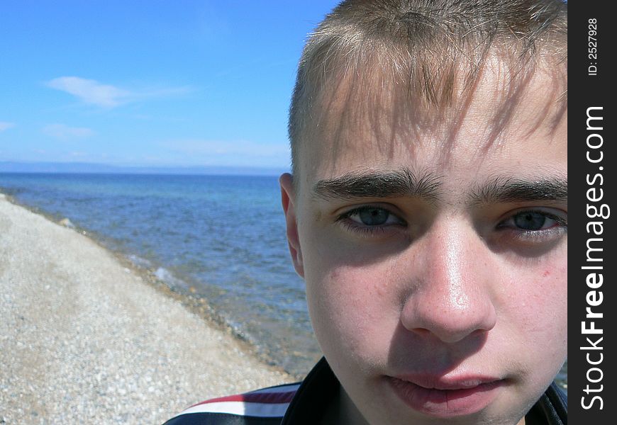 Ace of the boy on a background of Baikal. Ace of the boy on a background of Baikal