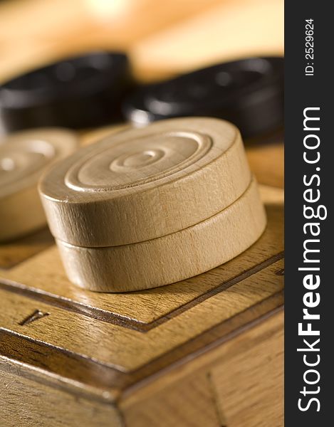 Checkers or draughts on a board close up
