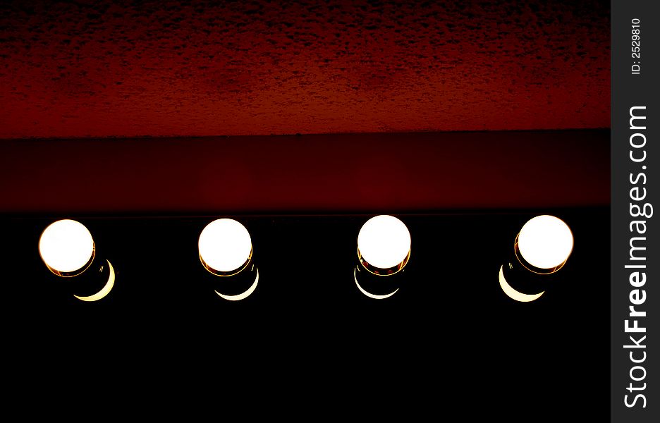 Four Light bulbs with a red background