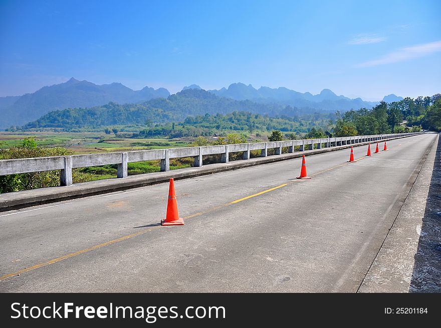 Country road with moutain background at Kanchanaburi,thailand. Country road with moutain background at Kanchanaburi,thailand.