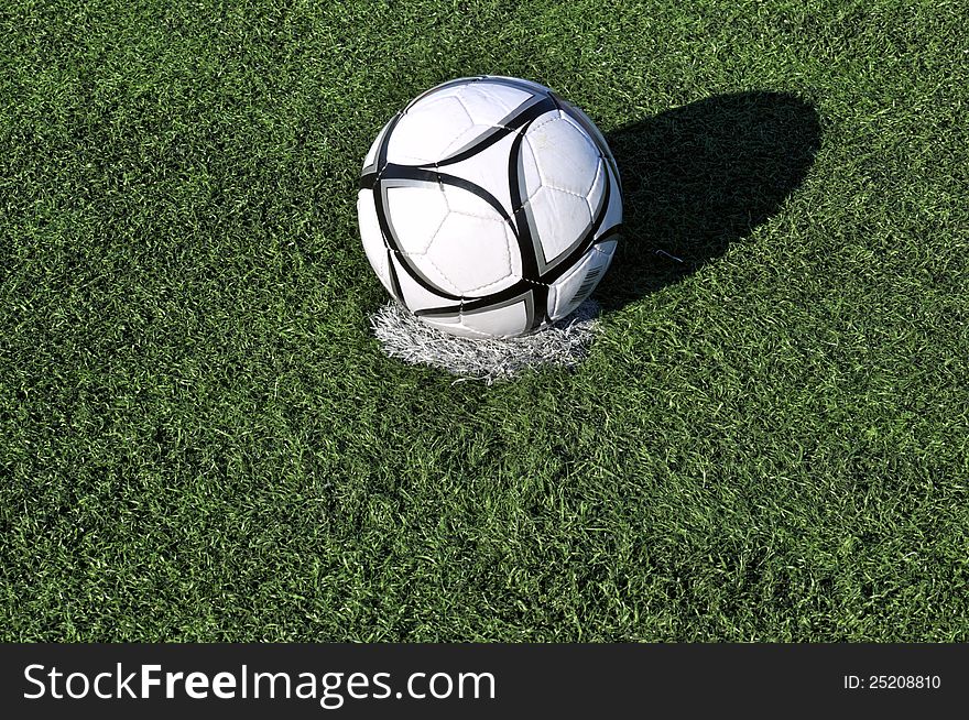 Football ball on apenalti point on a  grass