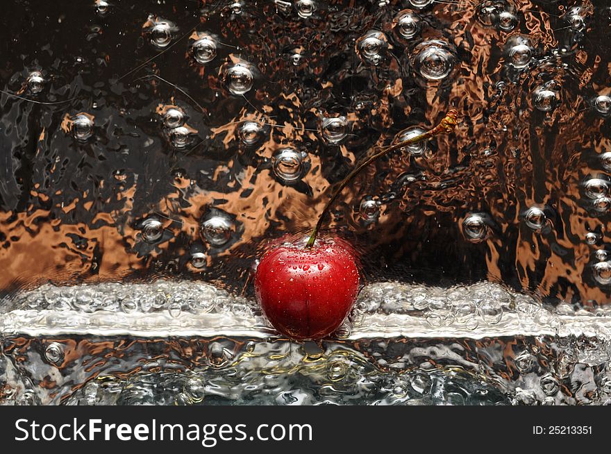 Red cherry in moving water and droplets. Red cherry in moving water and droplets