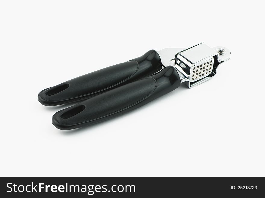 Single garlic press on white background