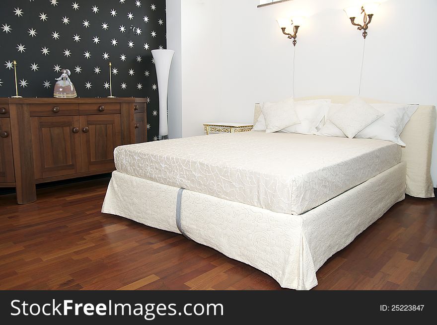 Bright bedroom with a queen size bed and cupboard