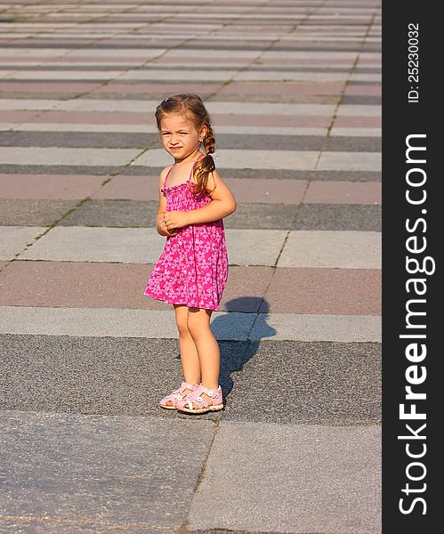 Alone little girl on a huge empty square