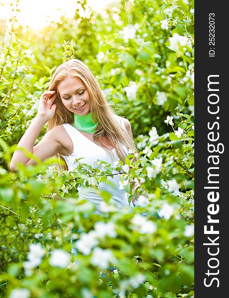 Beautiful blonde girl in the garden on a sunny day