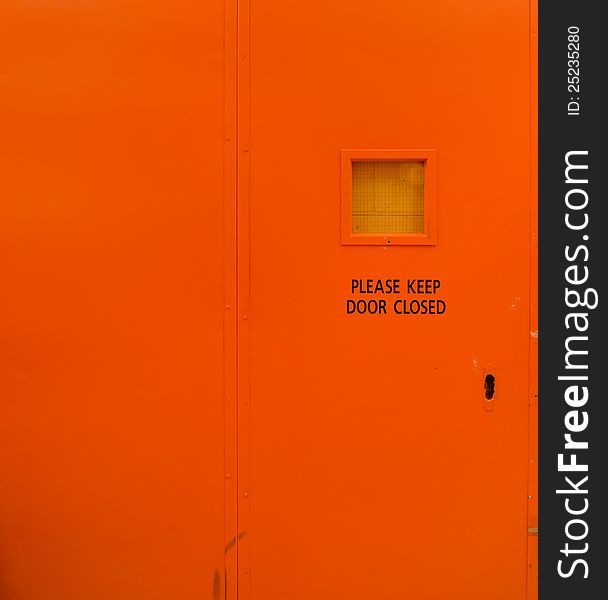 Bright orange door marked with 'please keep door closed'.