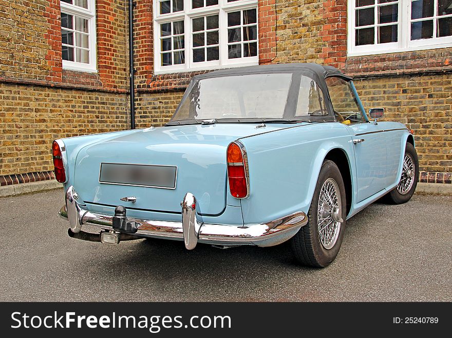 Photo of a classic car triumph tr4 in wedgwood blue with soft top hood. Photo of a classic car triumph tr4 in wedgwood blue with soft top hood.