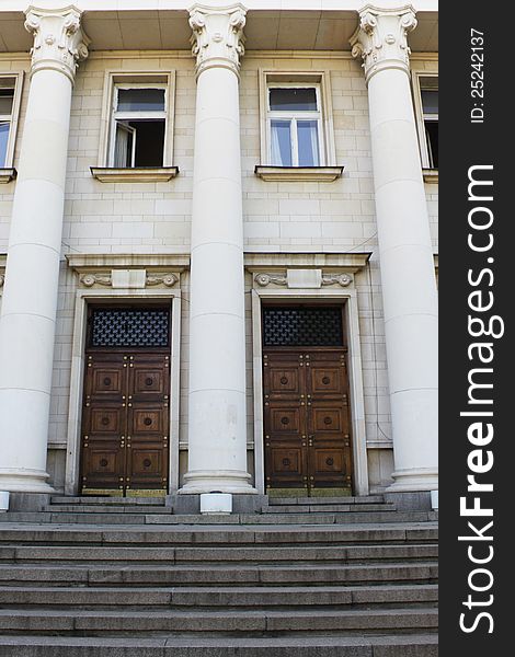 Image of two identical wooden doors with stairs in front of them. Image of two identical wooden doors with stairs in front of them