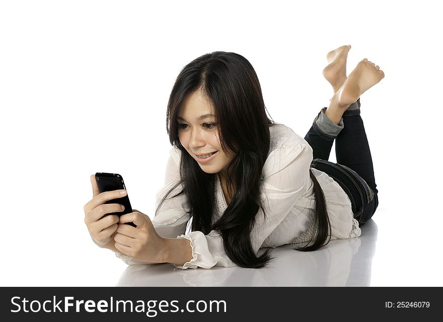 Asian woman lay on the floor while texting her friend. Asian woman lay on the floor while texting her friend