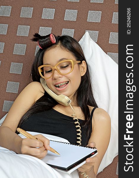 Asian woman call and write while in bed. Asian woman call and write while in bed