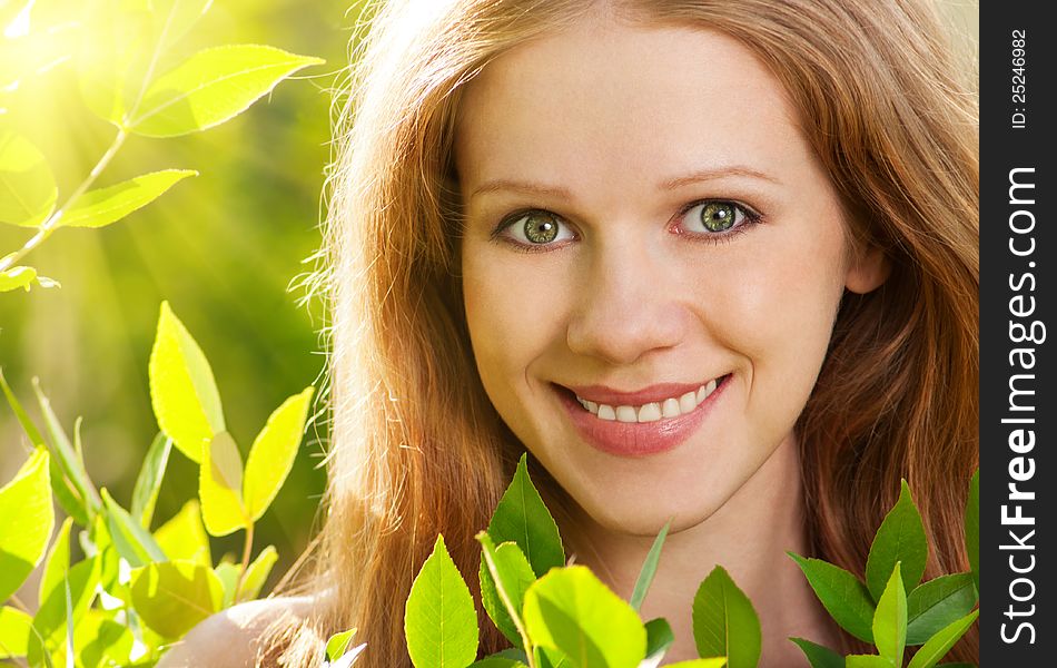 Beauty girl in nature with green leaves