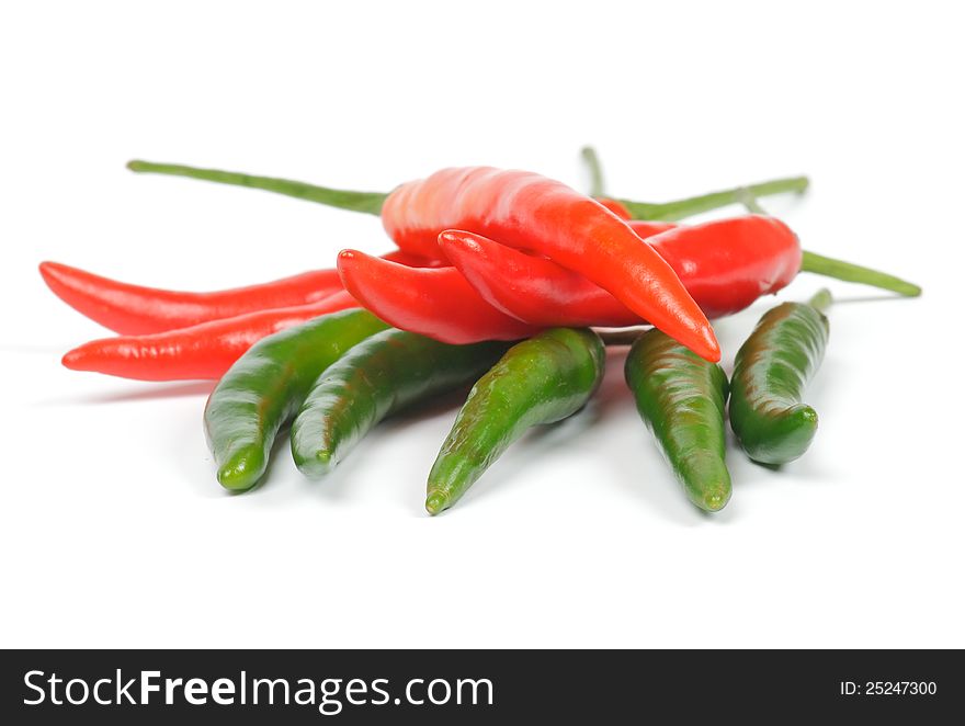 Arrangement of green and red chili peppers isolated in white background. Arrangement of green and red chili peppers isolated in white background