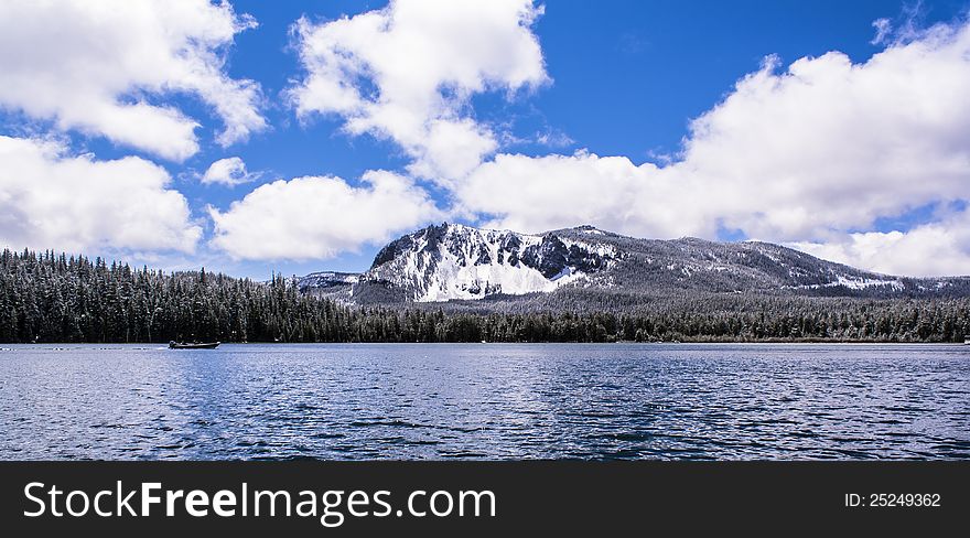 Paulina Lake with Paulina Peak in background during the Spring. Light snow cover. Paulina Lake with Paulina Peak in background during the Spring. Light snow cover.