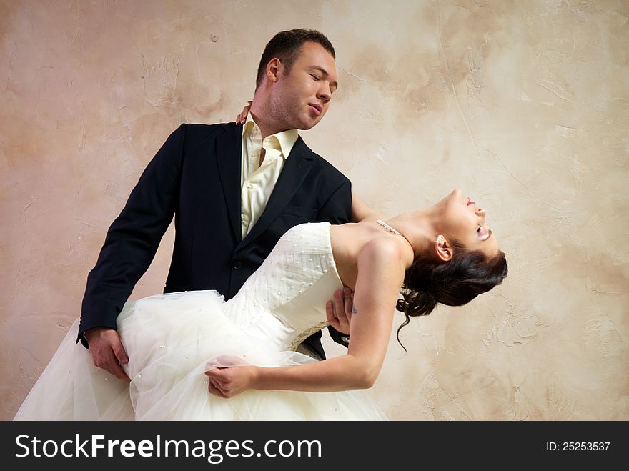 Bride and groom hugging in empty room