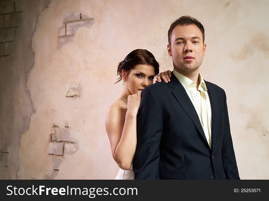 Bride and groom standing in stylish empty room. Bride and groom standing in stylish empty room