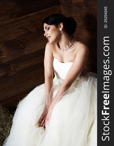 Bride with tattoo posing in the barn with hay. Bride with tattoo posing in the barn with hay