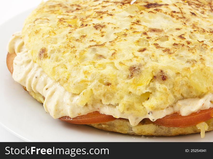 Spanish typical food. Spanish omelette stuffed with rice cream and tomato. Made with potatoes, onion and olive oil. Spanish typical food. Spanish omelette stuffed with rice cream and tomato. Made with potatoes, onion and olive oil.