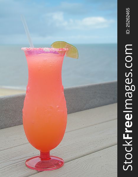 Refreshing frozen cocktail served at the beach on a sunny day