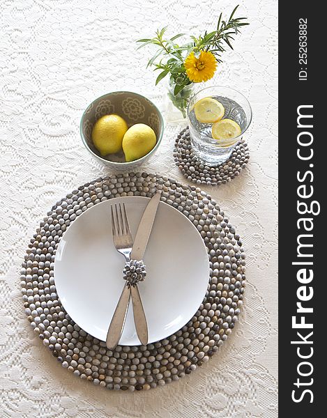 Table place setting with beaded mats and lace cloth