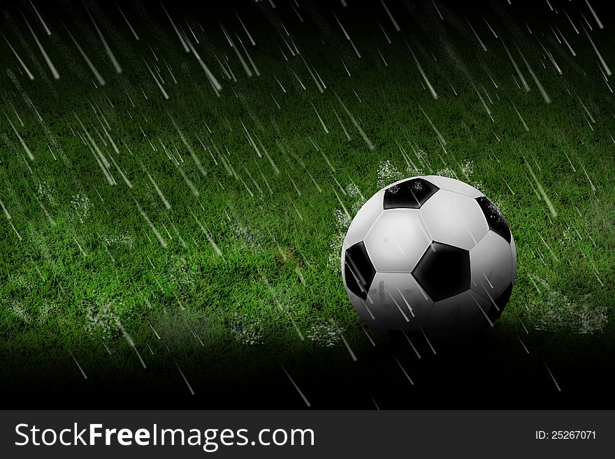 A soccer ball on grass and raining. A soccer ball on grass and raining