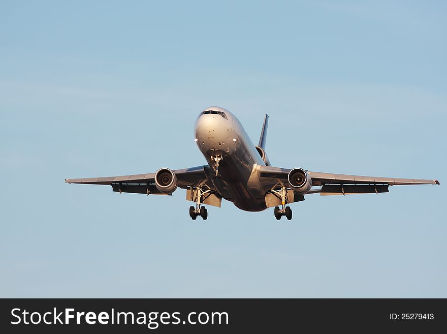 Front view of a large cargo aircraft landing. Front view of a large cargo aircraft landing