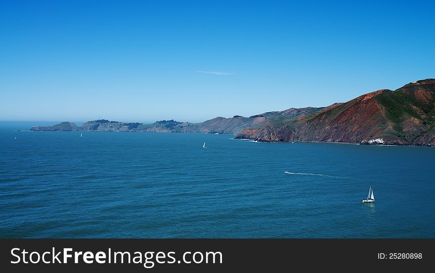 Top view on pacific ocean coastline of California, close to San-Francisco bay, with yachts and boats. Top view on pacific ocean coastline of California, close to San-Francisco bay, with yachts and boats