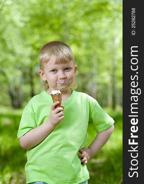 Happy kid eating a tasty ice cream outdoors