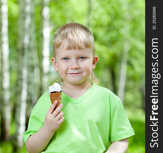 Child eating a tasty ice cream outdoors
