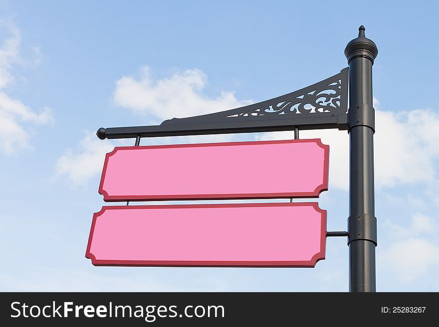 Pink wood sign with blue sky as background