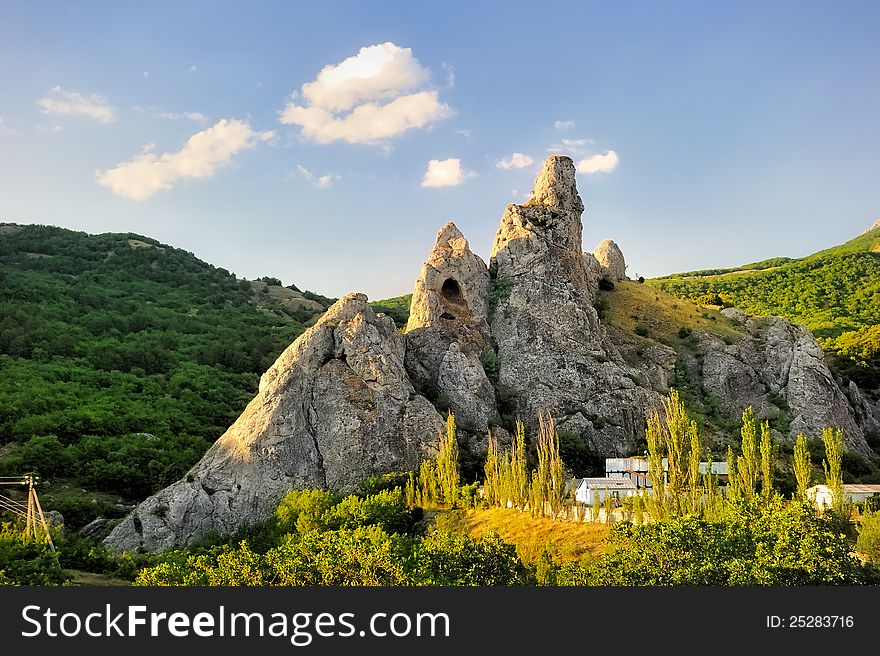 Rock surrounded by green mountains. The Crimean peninsula. Ukraine.