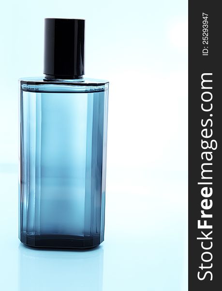 Blue perfume bottle with reflection