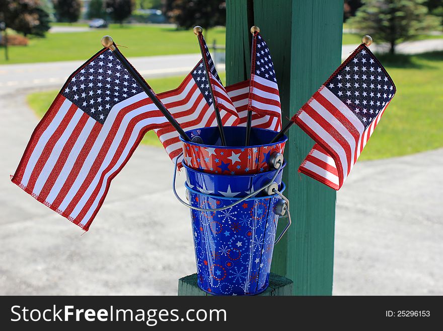 Pretty little patriotic buckets with American flags displayed to celebrate the 4th of July. Pretty little patriotic buckets with American flags displayed to celebrate the 4th of July.
