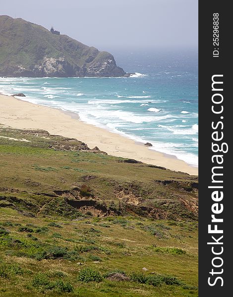 A lonely California lighthouse stands guard over the Pacific Ocean.