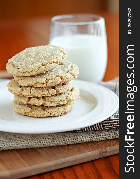 Stack of browned butter sugar cookies with milk.