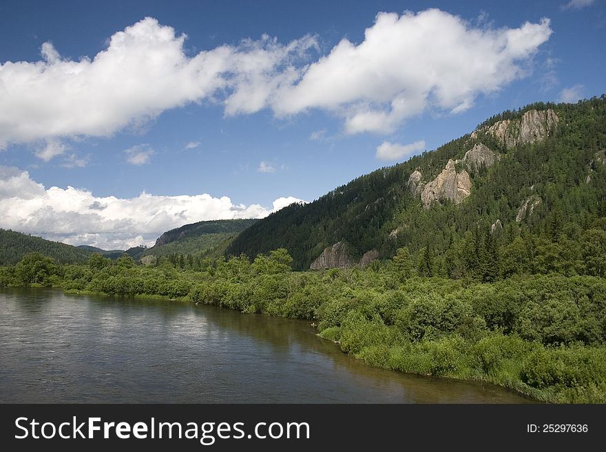 A river landscape with clouds.