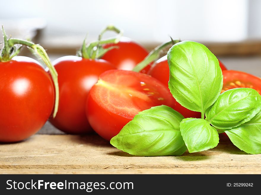 Basil with tomatoes in the background