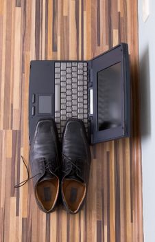 Mans Shoes On The Notebook Stock Images