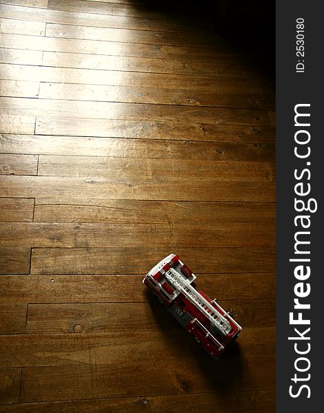 Vintage firetruck model toy on parquet floor