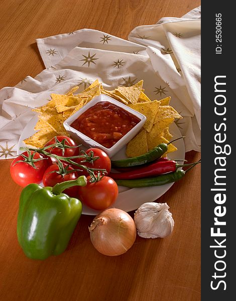 Salsa and its ingredients on a table setting See more food pictures. Salsa and its ingredients on a table setting See more food pictures.