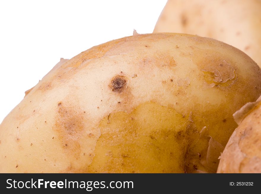 Raw Jersey Royal potatoes shot against a white background