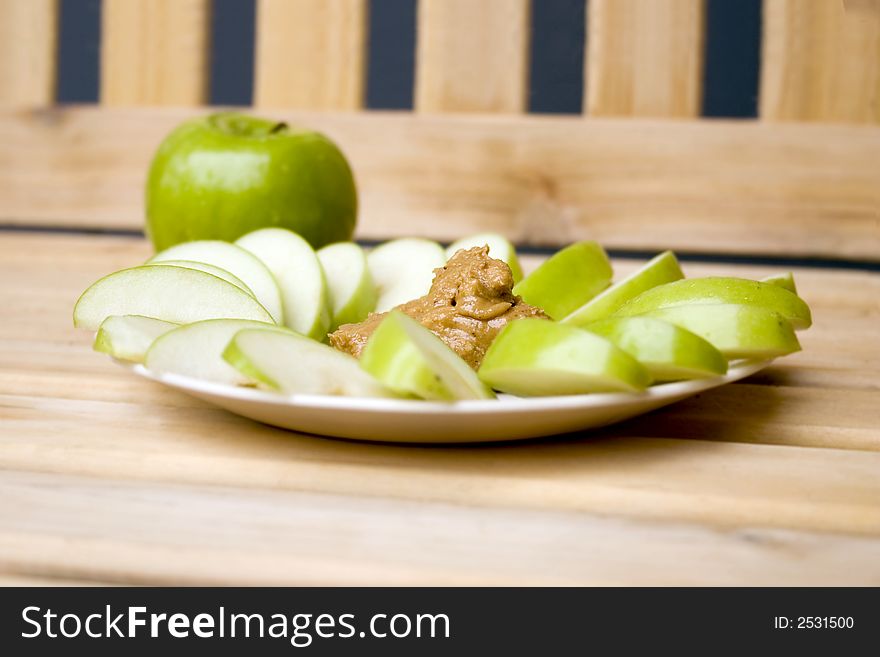 A plate of apples and peanutbutter. A plate of apples and peanutbutter