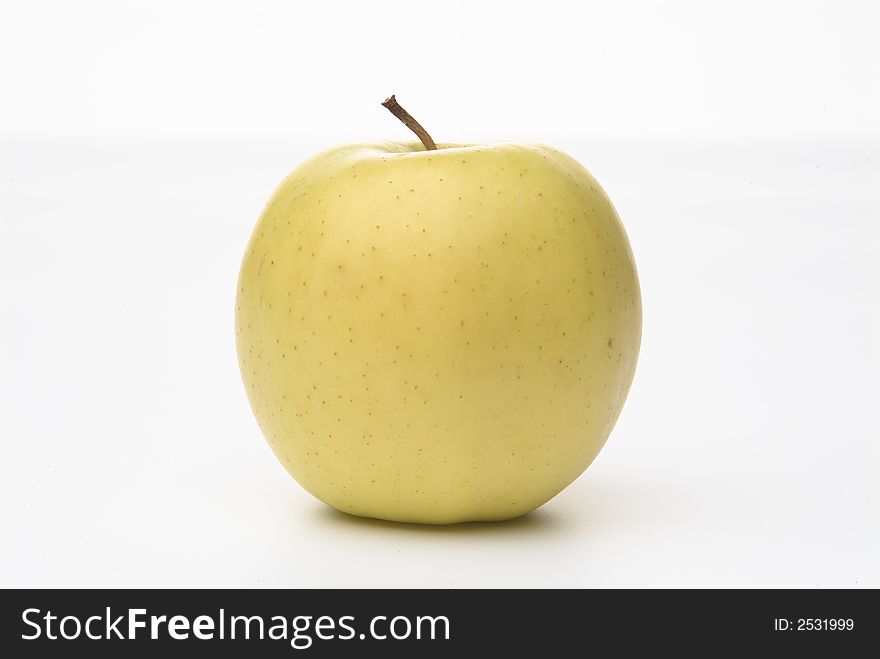 Photograph on a white back ground of an yellow green apple. Photograph on a white back ground of an yellow green apple.