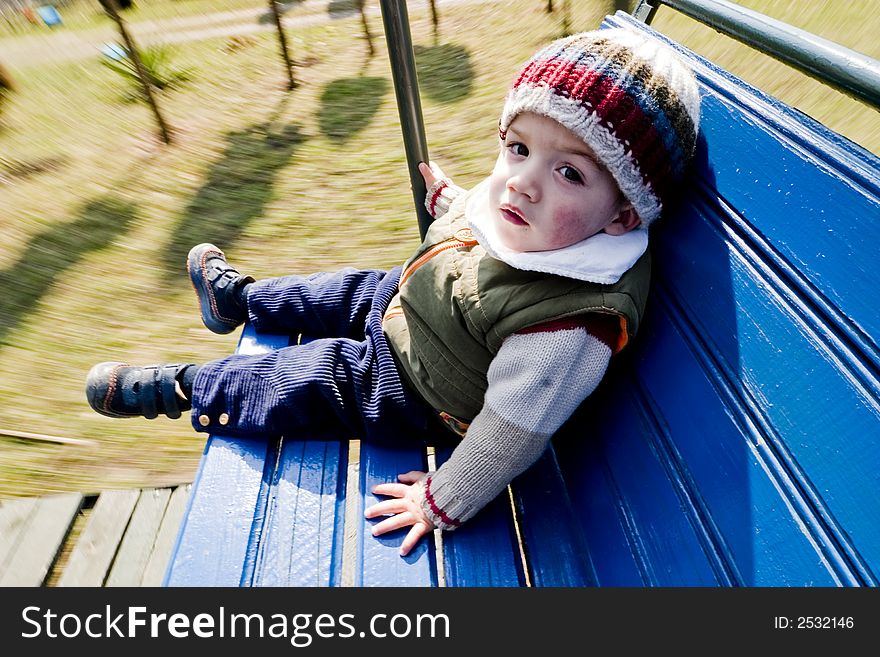 Child sitting on wooden swing bench. Child sitting on wooden swing bench