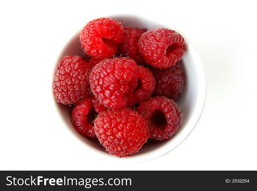 A still life of a bowl of ripe raspberries. A still life of a bowl of ripe raspberries